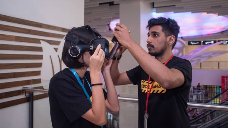 Festival Volunteer assisting the audience with the VR googles